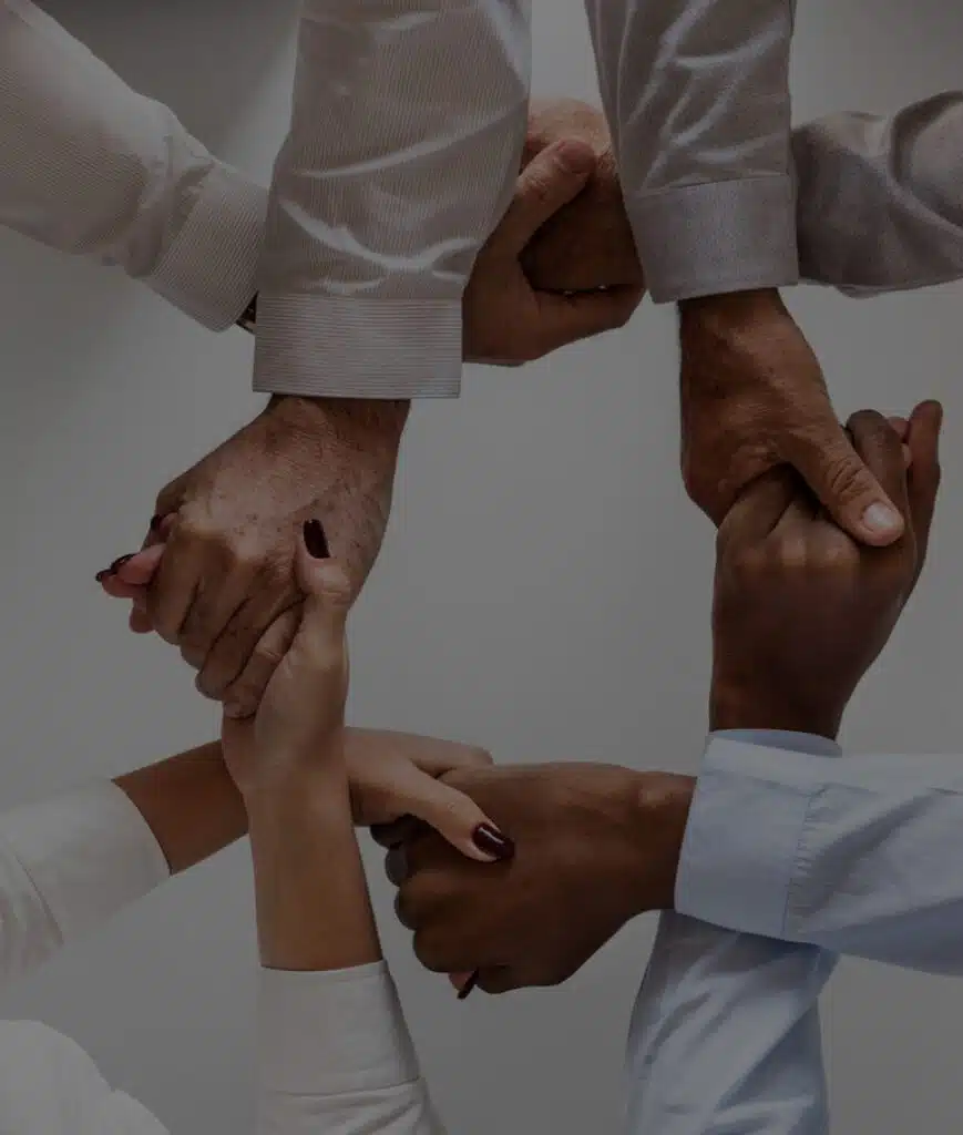 Hands joined in collaborative teamwork circle